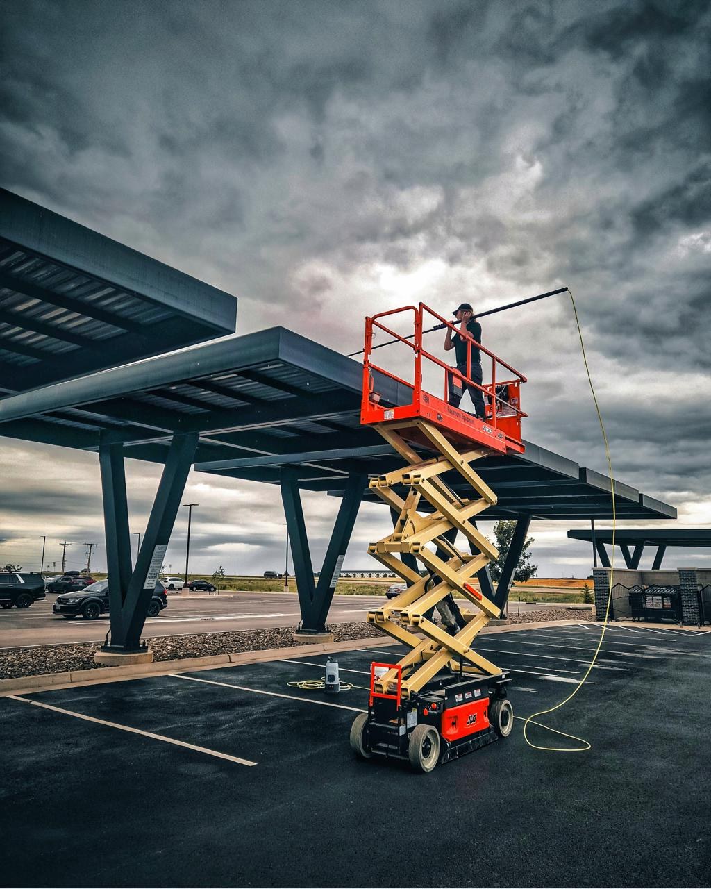 Commercial solar canopy cleaning from a scissor lift